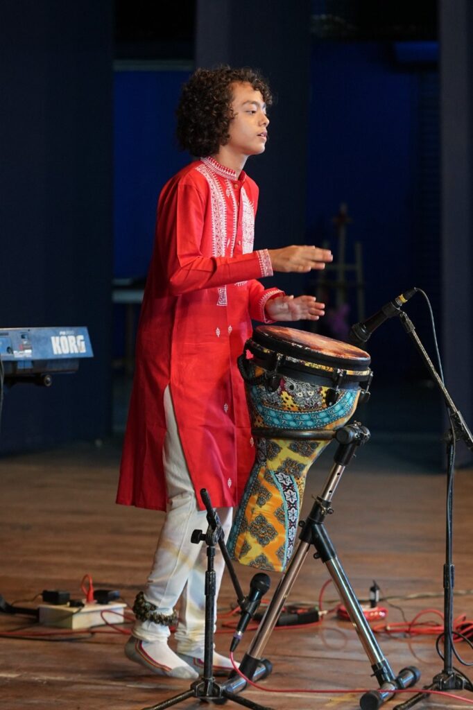 Aurum performing on the djembe under stage lights