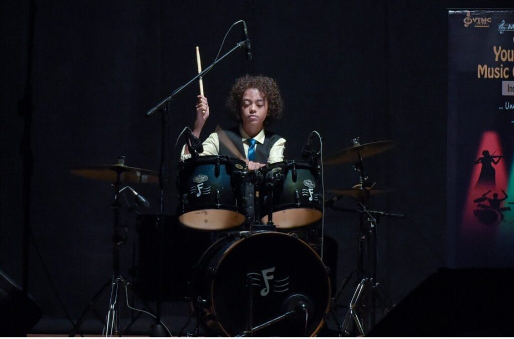 Aurum with drumsticks raised at the kit