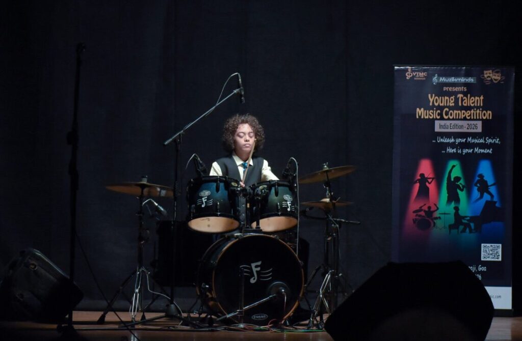 Aurum performing on drums under stage lights