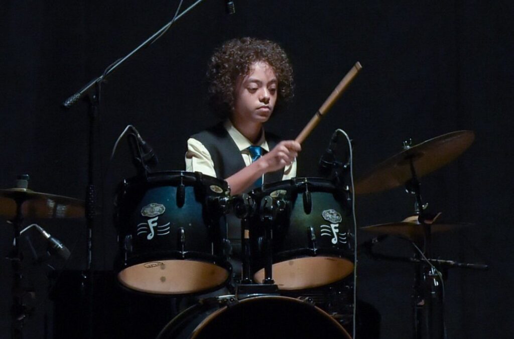 Close view of Aurum striking the drums