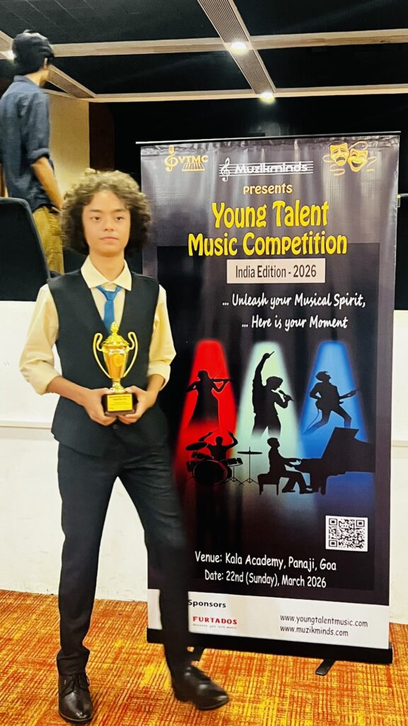 Aurum smiling beside an event banner